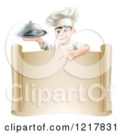 Poster, Art Print Of Happy Young Male Chef Holding A Cloche And Pointing Down At A Scroll