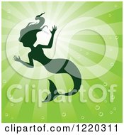 Clipart Of A Silhouetted Swimming Mermaid Over Green Rays Royalty Free Vector Illustration