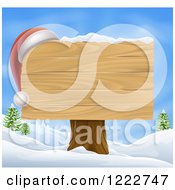 Poster, Art Print Of Wooden Christmas Sign With A Santa Hat In A Winter Landscape Over Blue Sky