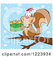Poster, Art Print Of Cute Christmas Squirrel Holding A Present On A Branch In The Snow