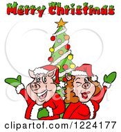 Clipart Of A Pig Couple By A Christmas Tree With Merry Christmas Text Royalty Free Vector Illustration