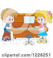 Caucasian Boy And Girl At A Piano