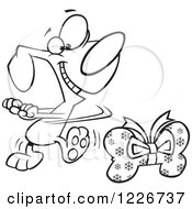 Clipart Of A Cartoon Outlined Happy Christmas Dog Doing A Happy Dance By A Bone Gift Royalty Free Vector Illustration