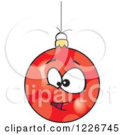 Clipart Of A Cartoon Red Goofy Christmas Bauble Royalty Free Vector Illustration by toonaday