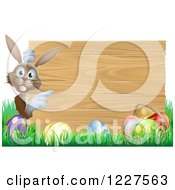 Brown Bunny By A Wood Sign And Easter Eggs