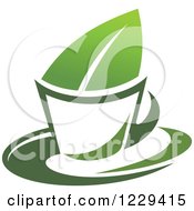 Clipart Of A Green Tea Cup And Leaf Royalty Free Vector Illustration