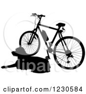 Clipart Of A Black Silhouetted Dog Resting By A Bicycle Royalty Free Vector Illustration by Maria Bell