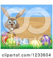 Poster, Art Print Of Brown Bunny Rabbit With A Basket And Easter Eggs By A Wooden Sign Under A Blue Sky