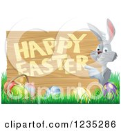 Clipart Of A Gray Bunny Pointing To A Happy Easter Sign With Easter Eggs In Grass Royalty Free Vector Illustration