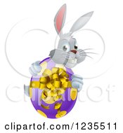 Clipart Of A Gray Bunny Rabbit Holding An Easter Egg Royalty Free Vector Illustration