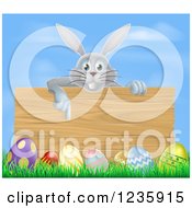 Clipart Of A Gray Bunny Pointing Down To A Wood Sign With Grass And Easter Eggs Royalty Free Vector Illustration