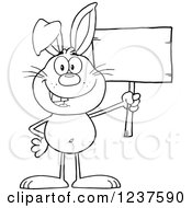 Clipart Of A Black And White Happy Rabbit Holding A Wooden Sign Royalty Free Vector Illustration