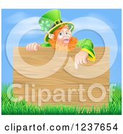 Poster, Art Print Of St Patricks Day Leprechaun Pointing Down To A Wooden Sign Over Grass And Sky
