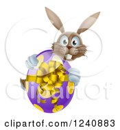 Clipart Of A Smiling Brown Bunny Hugging A Polka Dot Easter Egg Royalty Free Vector Illustration