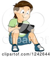 Poster, Art Print Of Boy Sitting On The Ground And Playing On A Tablet Computer