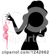 Clipart Of A Silhouetted Woman Holding A Pink Bra Royalty Free Vector Illustration