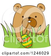 Poster, Art Print Of Brown Bear With An Easter Egg In Grass