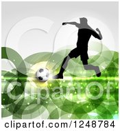 3d Soccer Ball And Silhouetted Male Player Over Green Rings