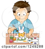Clipart Of A Happy Brunette Boy Painting A Rabbit Figurine Royalty Free Vector Illustration