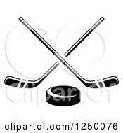 Clipart Of A Black And White Hockey Puck And Crossed Sticks Royalty Free Vector Illustration