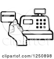 Black And White Hand Holding A Credit Card Over A Cash Register