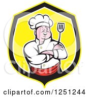 Laughing Asian Male Chef Holding A Spatula In A Yellow And Black Shield