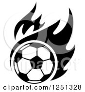 Clipart Of A Black And White Soccer Ball And Flames Royalty Free Vector Illustration