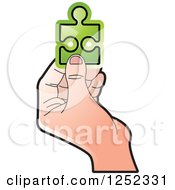 Clipart Of A Hand Holding A Green Jigsaw Puzzle Piece Royalty Free Vector Illustration by Lal Perera