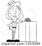 Clipart Of A Black And White Happy Grandma Christmas Elf With A Big Gift Royalty Free Vector Illustration by Cory Thoman