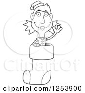 Clipart Of A Black And White Woman Christmas Elf Waving In A Stocking Royalty Free Vector Illustration by Cory Thoman