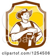 Retro Male Farmer Resting An Arm On A Shovel In A Brown And Yellow Shield