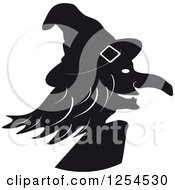 Clipart Of A Black And White Witch In Profile Royalty Free Vector Illustration