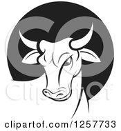 Clipart Of A Black And White Bull Over A Circle Royalty Free Vector Illustration by Lal Perera