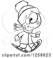 Clipart Of A Black And White Cartoon Boy Walking In Snowshoes Royalty Free Vector Illustration