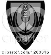 Clipart Of A Grayscale American Football In A Shield Royalty Free Vector Illustration by Chromaco