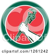 Retro Woodcut Plumber Hand Holding A Monkey Wrench In A Green White And Red Circle