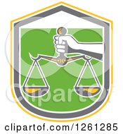 Poster, Art Print Of Hand Holding Scales Of Justice In A Yellow White Gray And Green Shield
