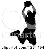 Clipart Of A Black Silhouetted Basketball Player In Action Royalty Free Vector Illustration