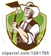 Poster, Art Print Of Retro Woodcut Cowboy Farmer Holding A Hoe Over A Shield Of Green Rays