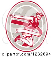 Clipart Of A Retro Male Runner Breaking Through A Finish Line In A Red Taupe And White Oval Royalty Free Vector Illustration