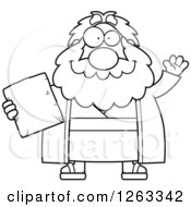 Black And White Cartoon Friendly Waving Chubby Moses Holding A Tablet