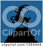 Poster, Art Print Of Black Silhouetted Rearing Rearing Buck Goat On A Mountain Peak Over Blue