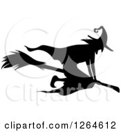 Clipart Of A Black Silhouetted Witch Flying On A Broomstick Royalty Free Vector Illustration by Vector Tradition SM