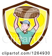 Clipart Of A Cartoon Male Mechanic Worker Holding Up A Tire In A Brown White And Yellow Shield Royalty Free Vector Illustration