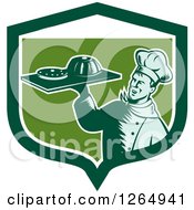 Retro Woodcut Male Chef Holding Gelatin Or Cake On A Platter In A Green And White Shield