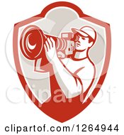 Clipart Of A Retro Cameraman Filming In A Shield Royalty Free Vector Illustration