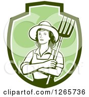 Retro Female Farmer Holding A Pitchfork In A Green And White Shield