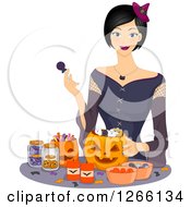 Poster, Art Print Of Young Asian Woman Dressed As A Witch Filling Halloween Pumpkins With Candy