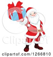 Poster, Art Print Of Santa Claus Holding Up A Blue And Red Christmas Gift