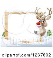 Poster, Art Print Of Happy Rudolph Red Nosed Reindeer Pointing Around A Blank Sign In The Snow